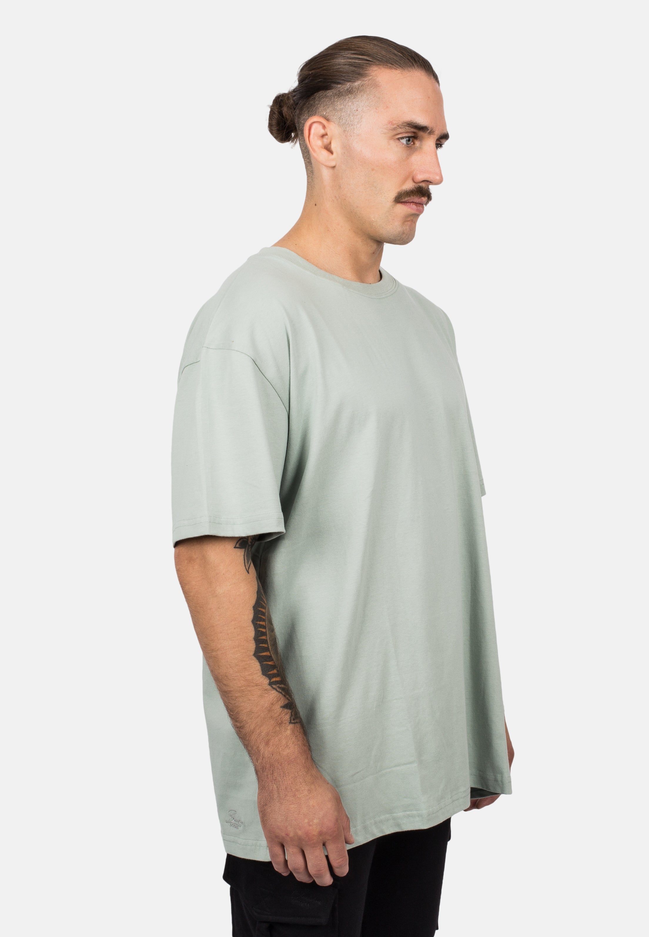 Blackskies-Unisex-Oversized-T-Shirt-Sage-Male-Model-Side-2
